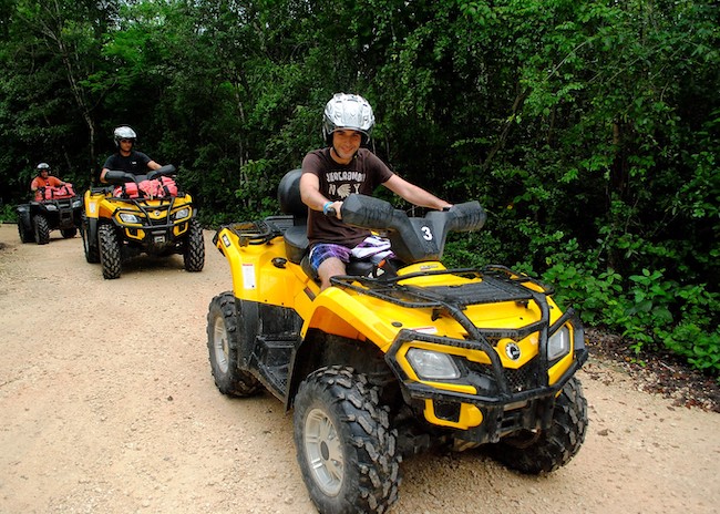 Robert and his party enjoying a sunny day while driving an ATV in Cozumel.