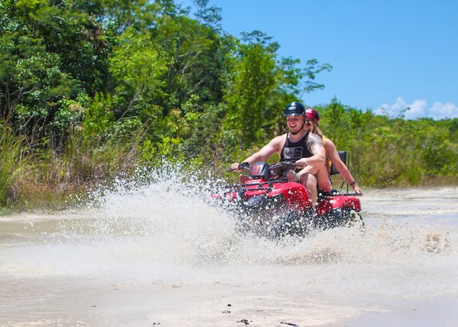 Mark passing a large puddle of water with his ATV.