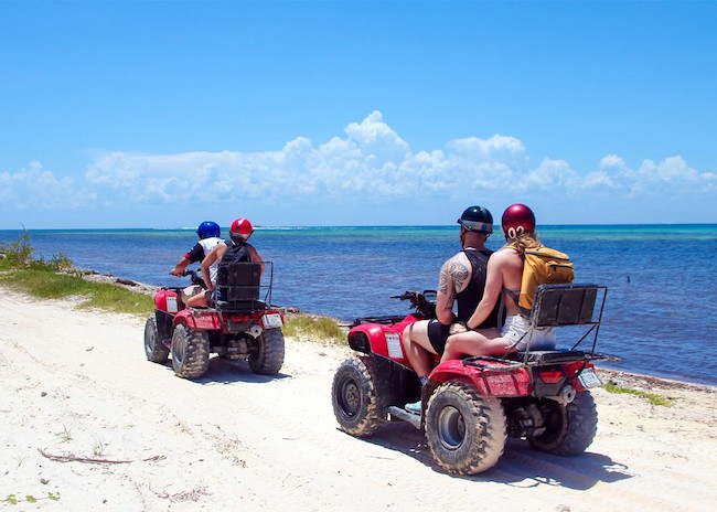 Mark and his family staring at the blue sea in Cozumel during an ATV excursion.